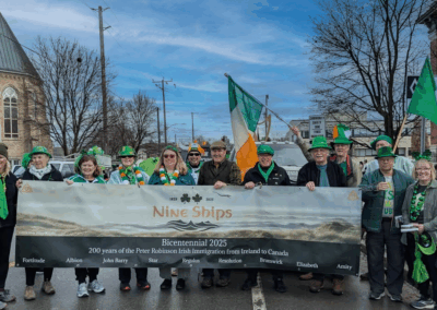 The Nine Ships 1825 Inc. group members holding the Nine Ships banner during the Peterborough St. Patricks day parade in 2025.